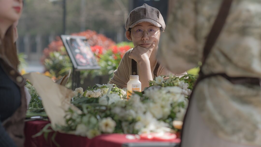 elderly woman selling flowers